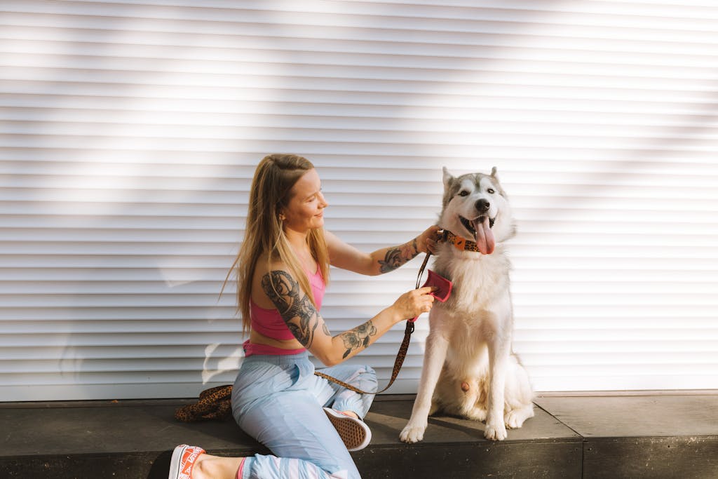 A stressed dog that hates being brushed turning away from a traditional grooming brush